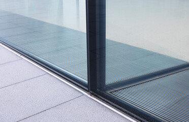 Insulated laminated glass wall Installed on the granite floor with gutter.