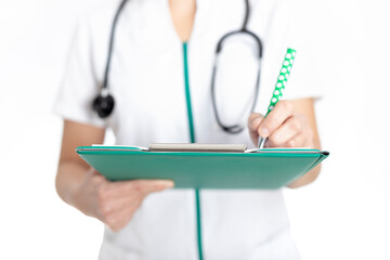 Doctor holding a green folder and writing. white background.