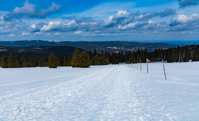 Snowy landscape of mountain trails and hills at cloudy morning