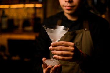 beautiful empty frosted martini wine glass in male hands