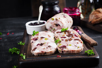 Delicious meat terrine with slice chicken, green peas and dried fruits. Meatloaf.