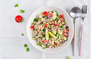 Tabbouleh salad. Traditional middle eastern or arab dish. Levantine vegetarian salad with parsley, cucumber, couscous, tomato. Top view, above