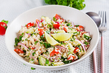 Tabbouleh salad. Traditional middle eastern or arab dish. Levantine vegetarian salad with parsley, cucumber, couscous, tomato.