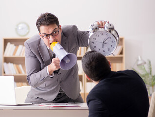 Angry boss shouting at his employee