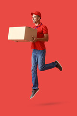 Jumping male courier with parcel on color background