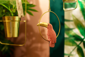 bright pink toucan. Decor element figurine tropical bird. Porcelain or ceramic statuette, souvenir, toy. Tropical garden in house. Decor home summer patio. indoor jungle	