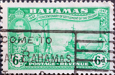 Bahamas - circa 1948: a postage stamp from Bahamas, showing scenes of tuna fishing with a ship at...