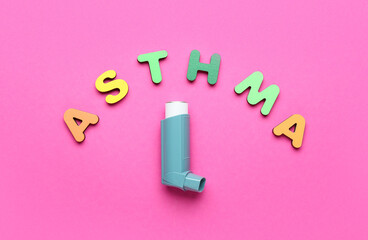 Word ASTHMA and modern inhaler on color background