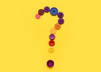 Question mark made of buttons on yellow background