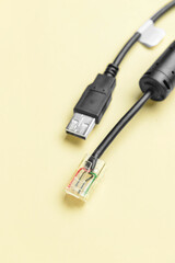 Internet and USB cables on beige background, closeup