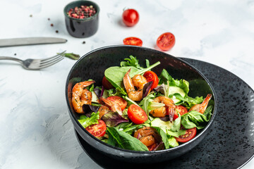 Dietary menu. Healthy vegan salad of smoked shrimps, cherry tomatoes, cucumber and mixed leaves. Healthy eating concept. Detox diet. Vegetarian lunch. Weight loss, top view