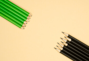 sharp-sharpened pencils lie against small pencils