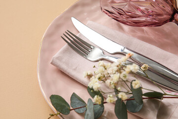 Stylish table setting on beige background