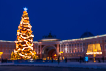 Completely out of focus night cityscape with big Christmas tree in front of building, St.Petersburg