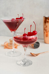 Glasses of tasty Manhattan cocktail on light background