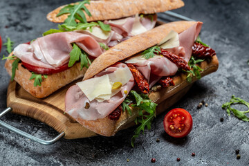 Turkey sandwich with ham, tomato, parmesan and arugula. appetizer bruschetta, Delicious breakfast or snack