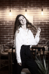 Portrait of a young beautiful long-haired girl. Vintage black and white photo.