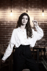 Portrait of a young beautiful long-haired girl. Vintage black and white photo.