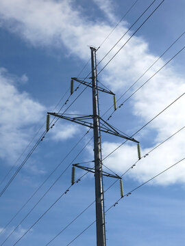 pole with wires (power line) on the background of a cloudy blue sky