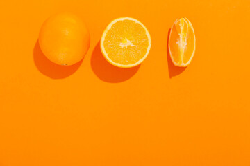 Fresh cut oranges on color background