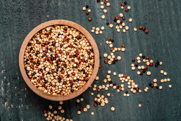 Obraz na płótnie Canvas Sets quinoa seeds on a wooden bowl. Healthy and diet superfood product. Long banner format, top view