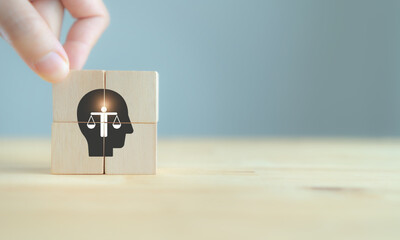 Business ethics concept. Ethics inside human mind. Business integrity and moral. The wooden cubes with ethics inside a head symbols on grey background and copy space. Company ethics culture. ESG. - obrazy, fototapety, plakaty