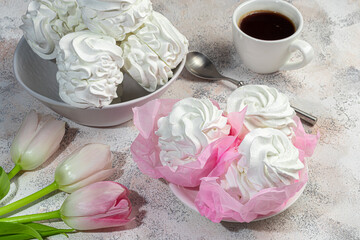 Handmade marshmallows on a light background in the form of roses, hydrangeas and tulips. There are flowers nearby. Women's day, Valentine's day.