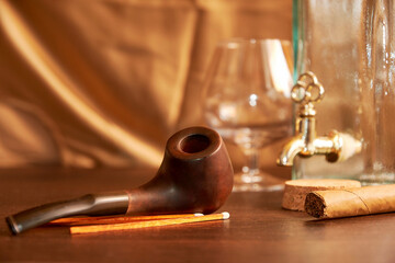 Smoking pipe with matches, empty wine bottle, and glass. Still life with elite men's accessories