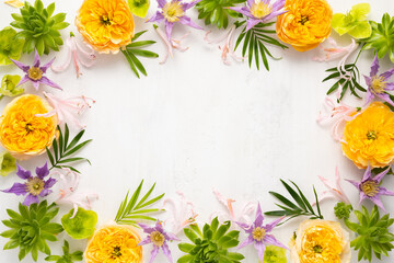 Composition of beautiful flowers, succulents and leaves on light background. Flowers frame.Top view, copy space.