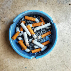 cigarette in blue ashtray