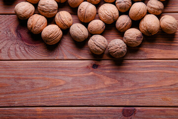 Whole walnuts with place for text on wooden background. A full source of vegetable protein. Concept - healthy eating.