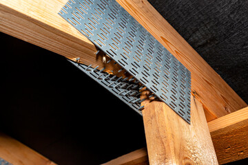 Barbed tile connecting the roof structure covered with a membrane on a single-family house, view...