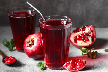 Glasses of delicious pomegranate juice on table