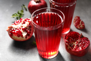 Glasses of delicious pomegranate juice on table