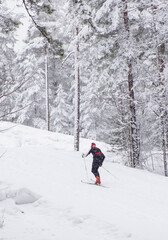 Girl athlete skier, runs on skis on the ski track. Winter sports.