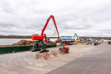 Fototapeta premium An aerial drone view of the industrial port in the Baltic Sea. There is a ships under load in the harbor. 