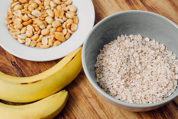 Ingredient of a milkshake banana, peanut and oatmeal healthy breakfast concept.