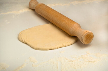 Dough and rolling pin with flour. Handmade, food