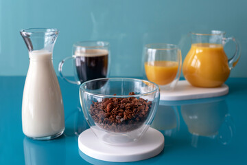 Chocolate granola with vegetable milk. coffee in a cup, orange juice for breakfast. Proper nutrition concept. Sugarless.