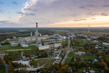 An aerial drone view of the industrial city in the Baltic. Plant for the production of concrete. Wind park.