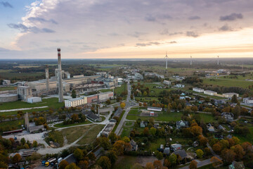 Obraz premium An aerial drone view of the industrial city in the Baltic. Plant for the production of concrete. Wind park.