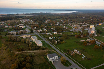 Obraz premium An aerial drone view of the industrial city in the Baltic. Plant for the production of concrete. Wind park.