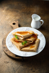 Homemade crepes with apricot jam