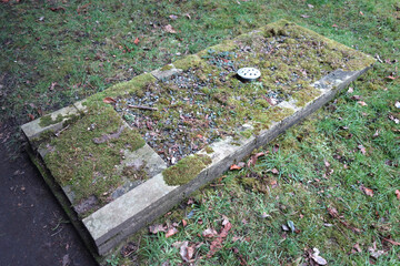 Old Graveyard with Broken and Fallen Crosses and Graves in Overgrown Grass Spooky