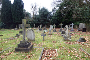 Old Graveyard with Broken and Fallen Crosses and Graves in Overgrown Grass Spooky