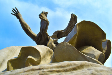 statue against the blue sky, view from below