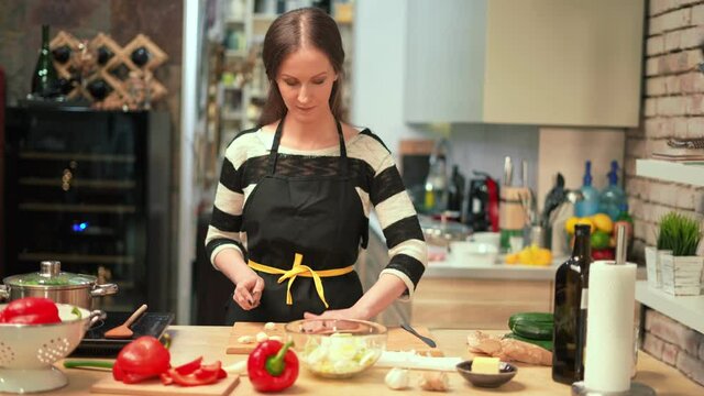 Young woman cooking in kitchen at home, healthy eating.