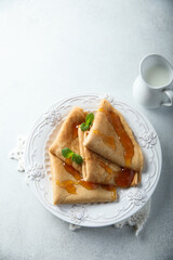 Homemade crepes with apricot jam