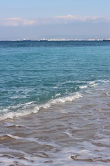 Clear blue sea water close up photo. Calm sea, blue sky,  tranquil scene. Warm day on the beach. 