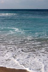 Clear blue sea water close up photo. Calm sea, blue sky,  tranquil scene. Warm day on the beach. 